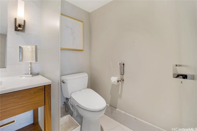 bathroom featuring tile patterned flooring, vanity, and toilet