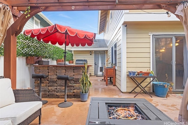 view of patio / terrace featuring a pergola and an outdoor fire pit