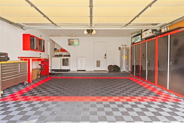 garage featuring electric water heater, separate washer and dryer, and a garage door opener