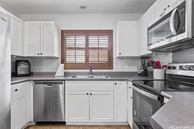 kitchen featuring white cabinetry, sink, appliances with stainless steel finishes, and tasteful backsplash