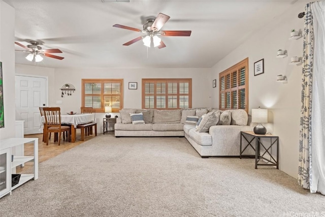 carpeted living room with ceiling fan