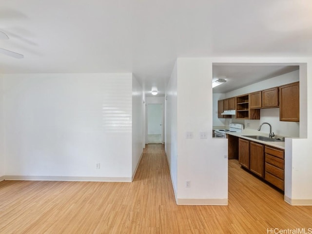 kitchen with ceiling fan, white electric range, sink, and light hardwood / wood-style flooring