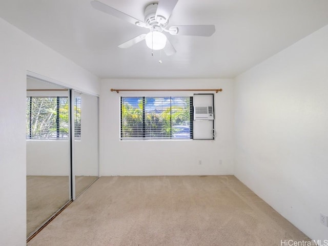 unfurnished bedroom with carpet flooring, ceiling fan, and a closet