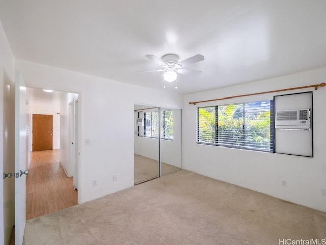 unfurnished bedroom with ceiling fan, light colored carpet, and a closet