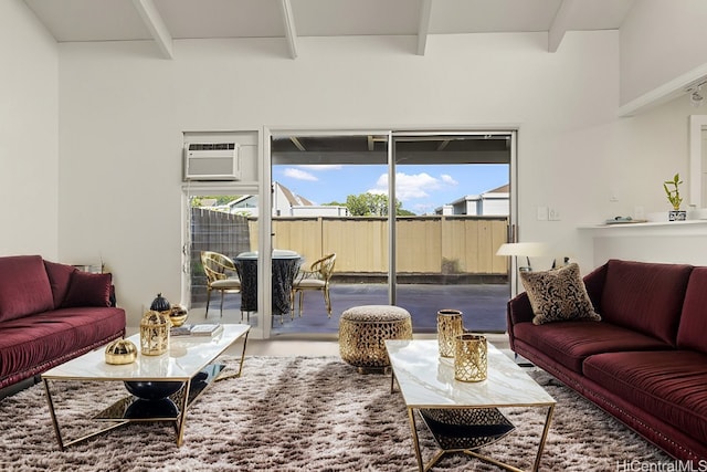 living room with beamed ceiling and a wall mounted AC