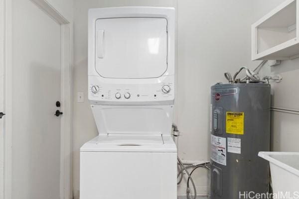 laundry area featuring electric water heater, sink, and stacked washer and clothes dryer