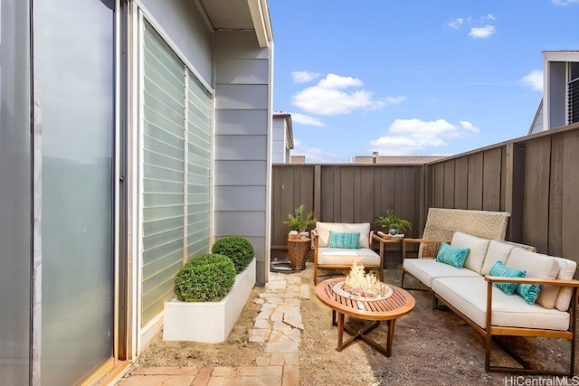 balcony featuring a patio area and an outdoor living space with a fire pit