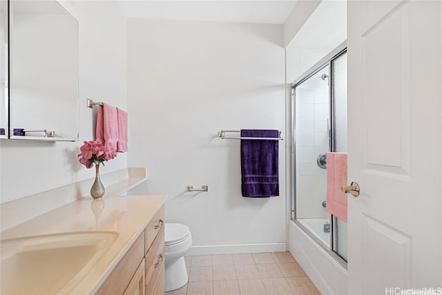 full bathroom with shower / bath combination with glass door, tile patterned flooring, vanity, and toilet