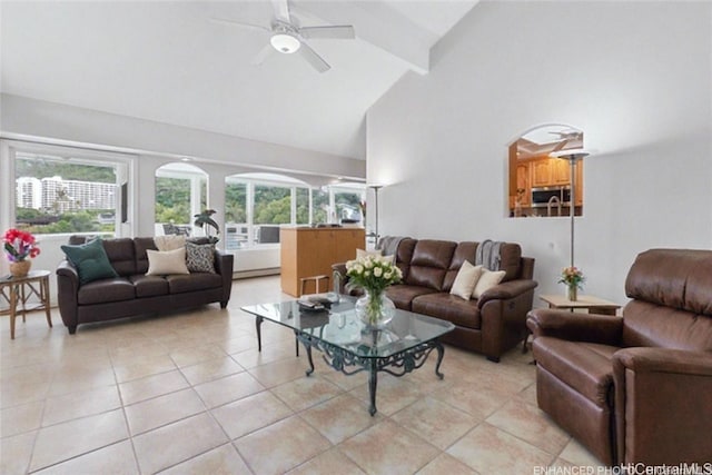 living room featuring vaulted ceiling with beams, light tile patterned floors, and a wealth of natural light