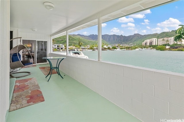 sunroom with a water and mountain view