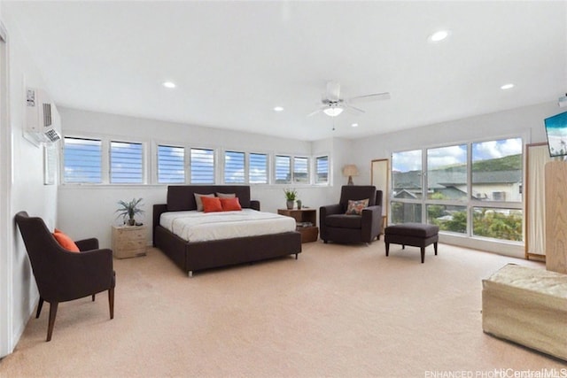 carpeted bedroom with ceiling fan, an AC wall unit, and multiple windows