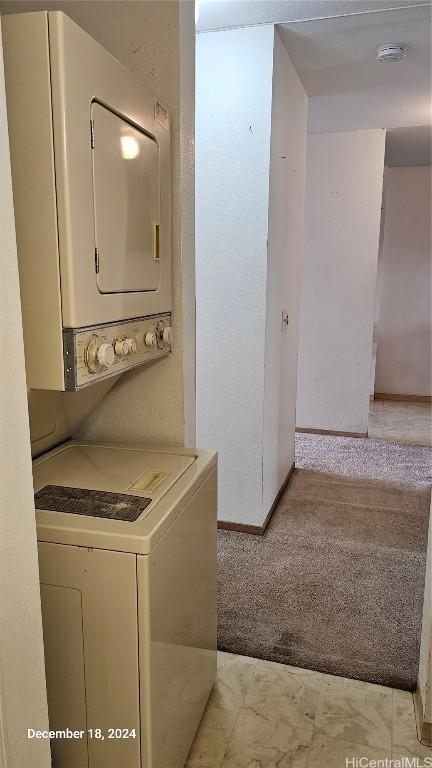 laundry area featuring stacked washing maching and dryer