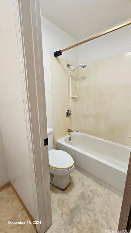 bathroom with shower / bathing tub combination and toilet