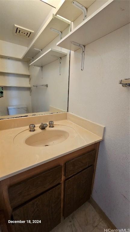 bathroom with vanity and toilet