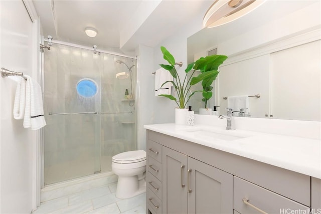 bathroom with vanity, an enclosed shower, and toilet