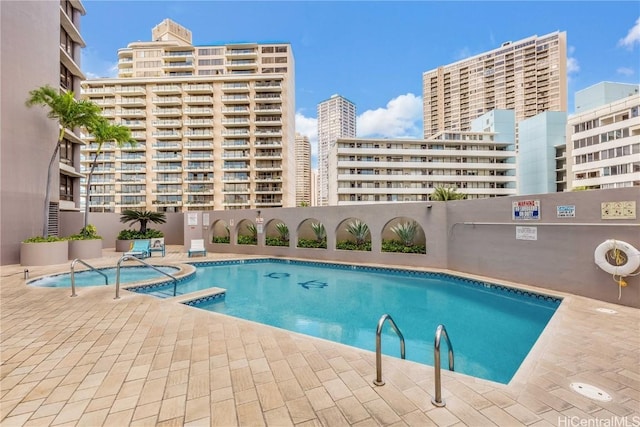 view of swimming pool with a community hot tub