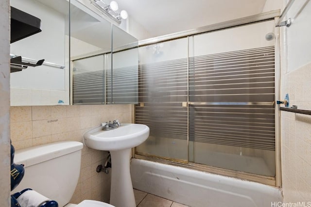 full bathroom with decorative backsplash, tile patterned floors, tile walls, and enclosed tub / shower combo