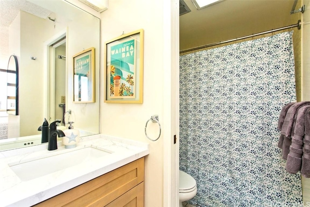 bathroom featuring vanity, a shower with shower curtain, and toilet