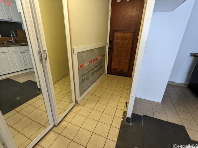 interior space featuring light tile patterned floors and sink