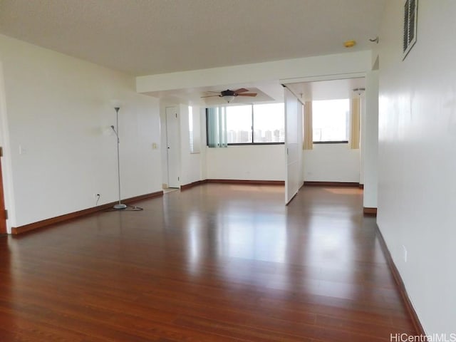 unfurnished room featuring ceiling fan and dark hardwood / wood-style flooring