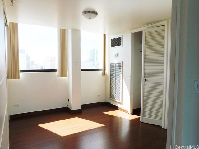 unfurnished room featuring dark hardwood / wood-style flooring