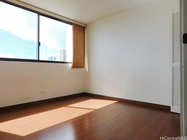 unfurnished room featuring hardwood / wood-style flooring