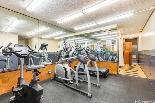 exercise room with a textured ceiling