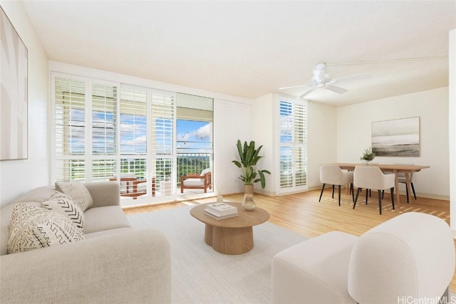 living room with wood-type flooring and ceiling fan