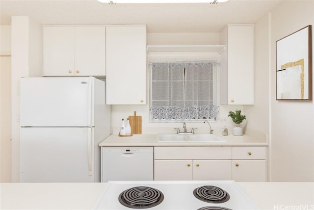 kitchen with white cabinets, white appliances, and sink