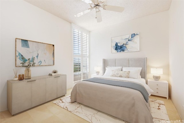 bedroom featuring multiple windows, ceiling fan, light colored carpet, and a textured ceiling