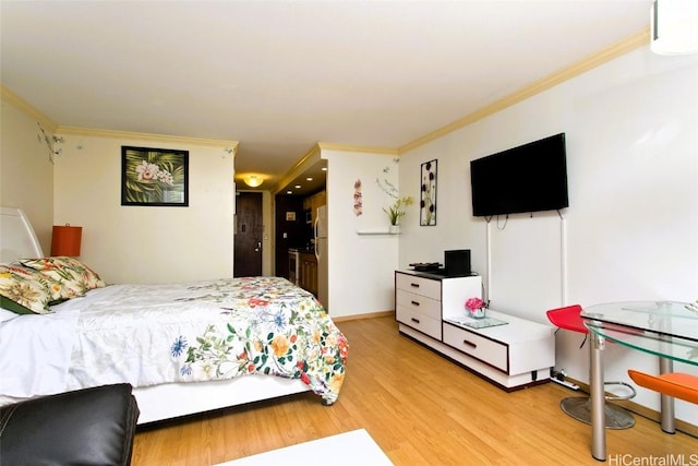 bedroom with ornamental molding and light hardwood / wood-style flooring