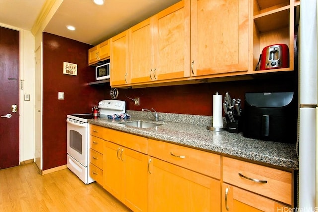 kitchen featuring sink, stone countertops, white appliances, and light hardwood / wood-style flooring