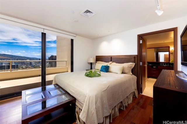 bedroom featuring a mountain view and wood-type flooring