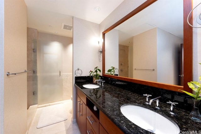 bathroom featuring tile patterned flooring, vanity, and an enclosed shower