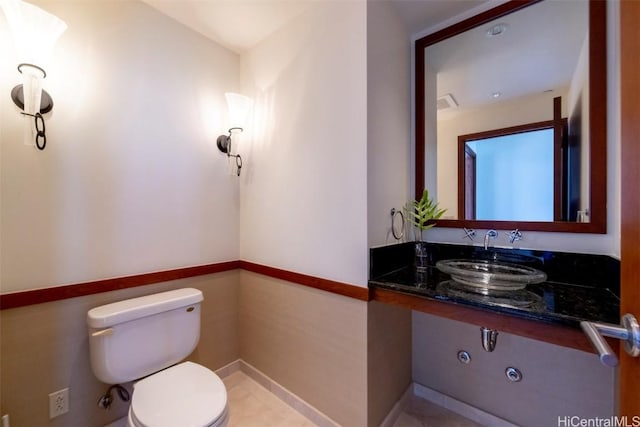 bathroom with tile patterned floors, toilet, and sink