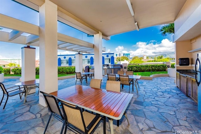 view of patio featuring a pergola and exterior kitchen