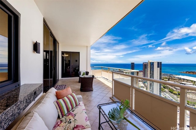 balcony featuring a water view and an outdoor hangout area