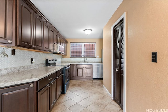 kitchen with light tile patterned floors, dark brown cabinetry, sink, and appliances with stainless steel finishes