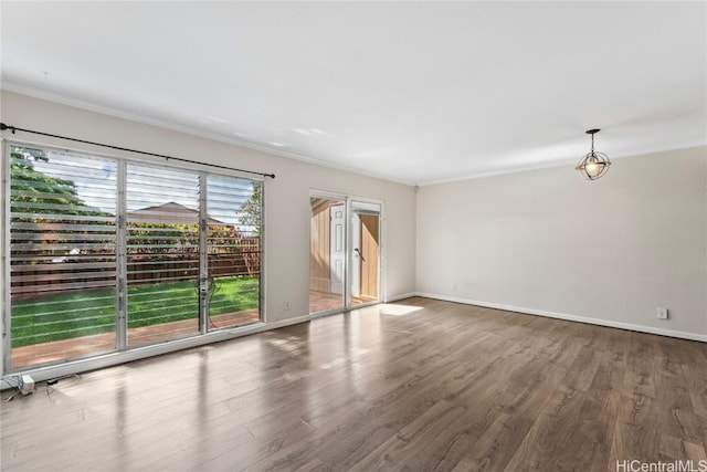 spare room with wood-type flooring and crown molding