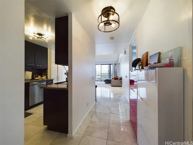 hallway with a notable chandelier and light tile patterned floors