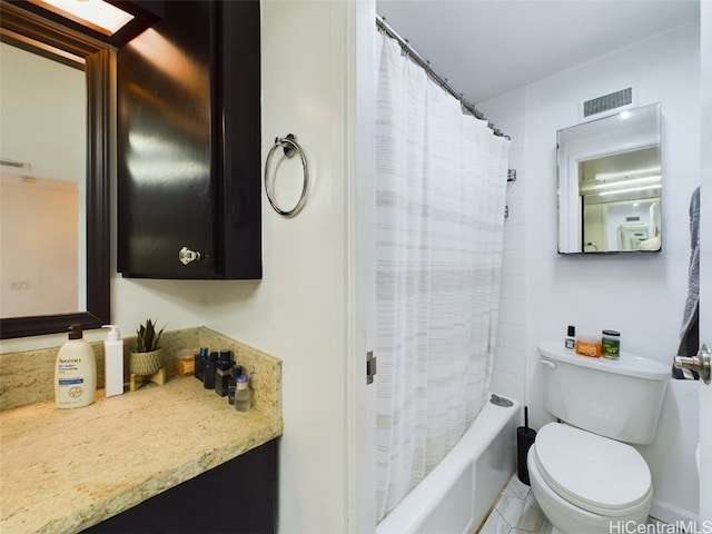 full bathroom with tile patterned floors, shower / tub combo with curtain, vanity, and toilet