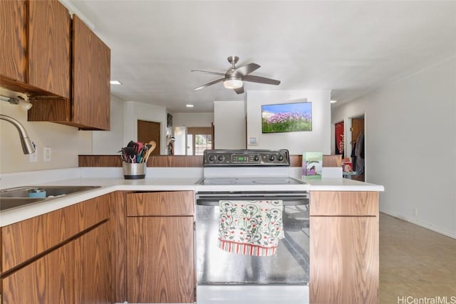 kitchen with kitchen peninsula, white electric stove, ceiling fan, and sink