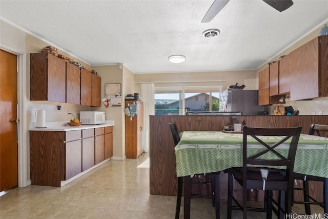 kitchen featuring a breakfast bar and a textured ceiling