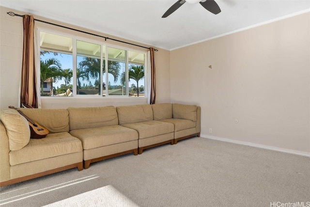 carpeted living room with ceiling fan and ornamental molding