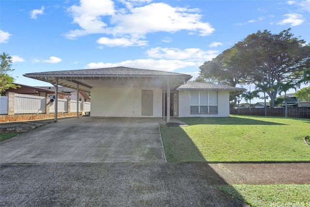 view of front of home with a front yard and a carport