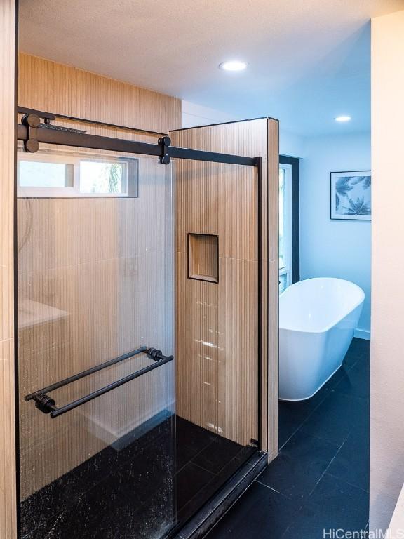 bathroom featuring tile patterned flooring and plus walk in shower