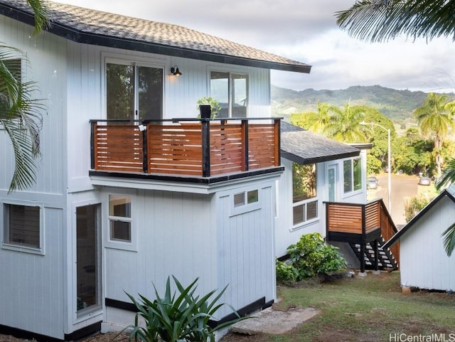 back of house featuring a mountain view and a balcony