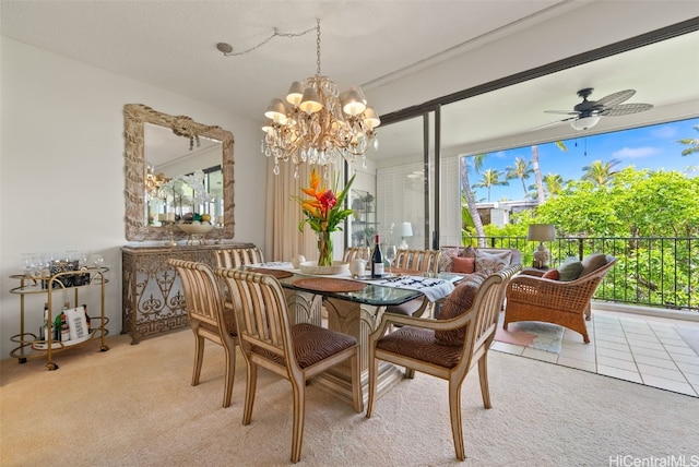 carpeted dining area with ceiling fan with notable chandelier