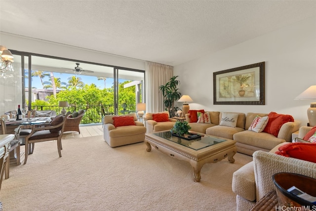 carpeted living room featuring a textured ceiling and ceiling fan