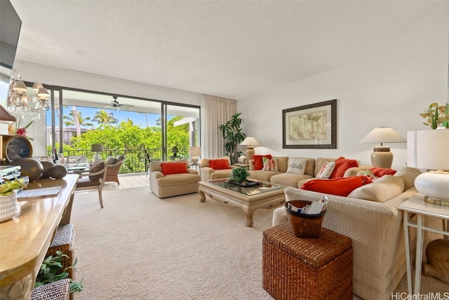 living room with carpet flooring, ceiling fan with notable chandelier, and a textured ceiling